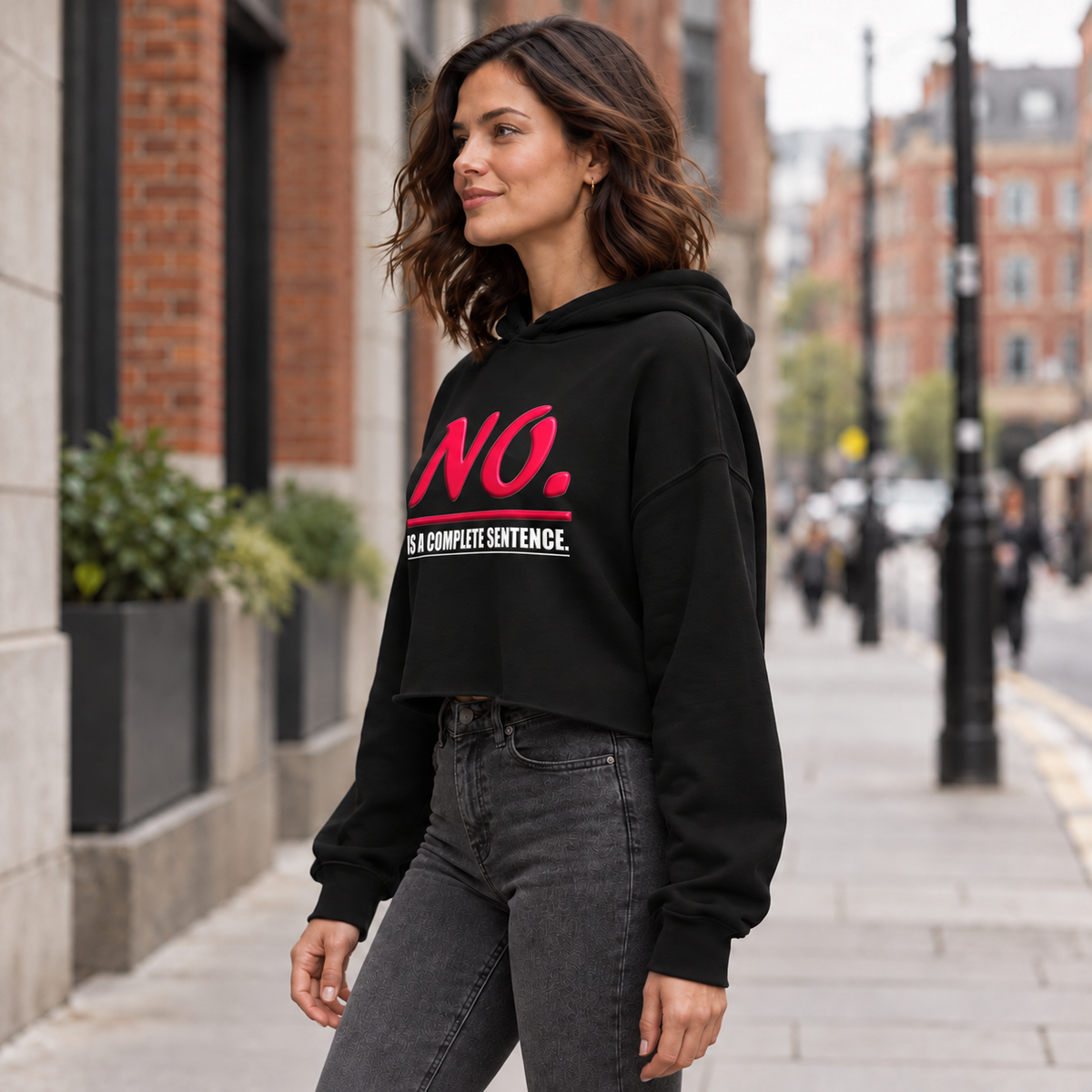 Black women’s cropped hoodie with glossy pink “NO.” lettering and white “IS A COMPLETE SENTENCE.” slogan.