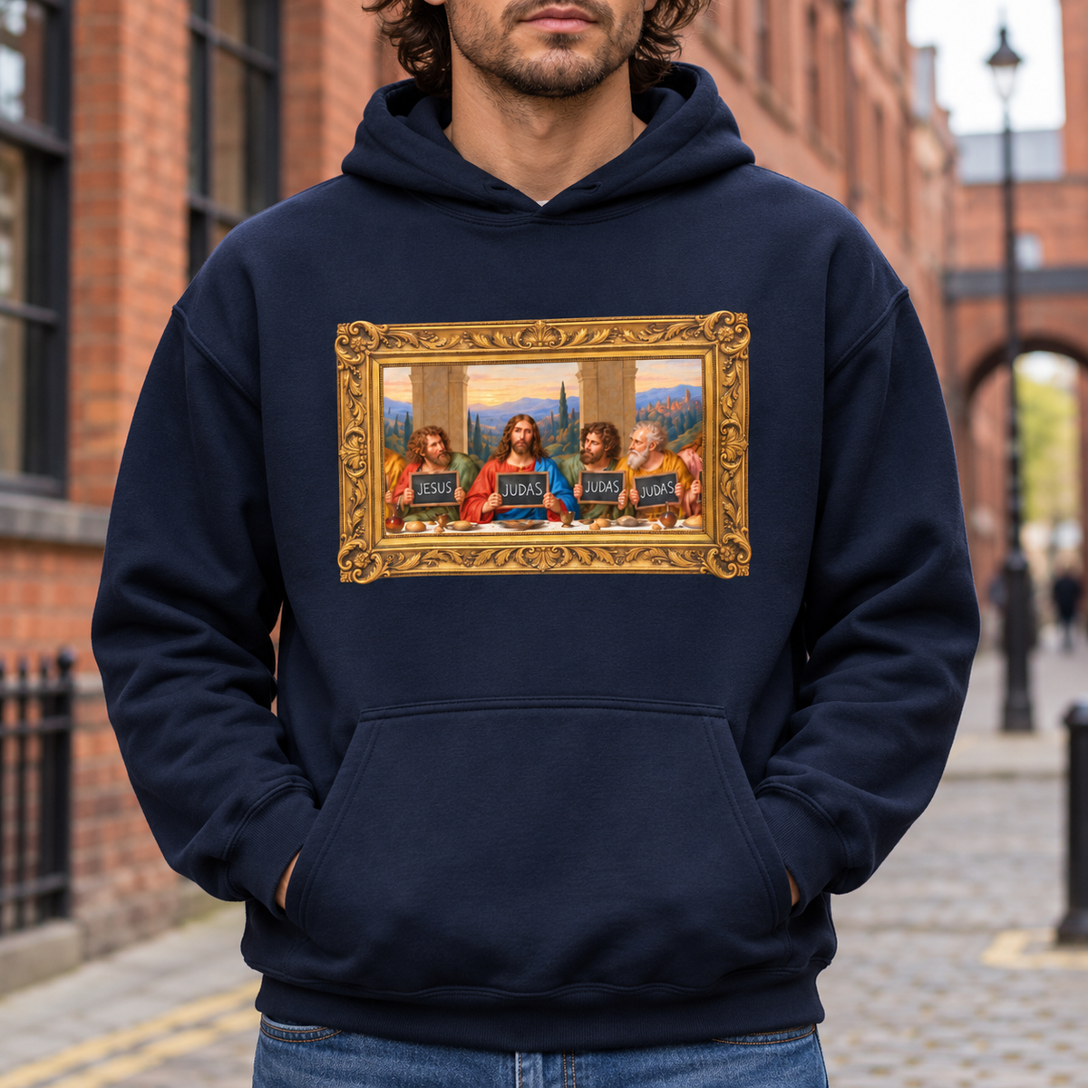 Navy hoodie featuring The Original Round Table Last Supper parody in a gold frame, with JESUS and JUDAS chalkboards.