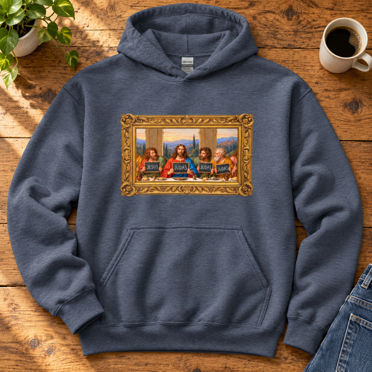Navy hoodie featuring The Original Round Table Last Supper parody in a gold frame, with JESUS and JUDAS chalkboards.
