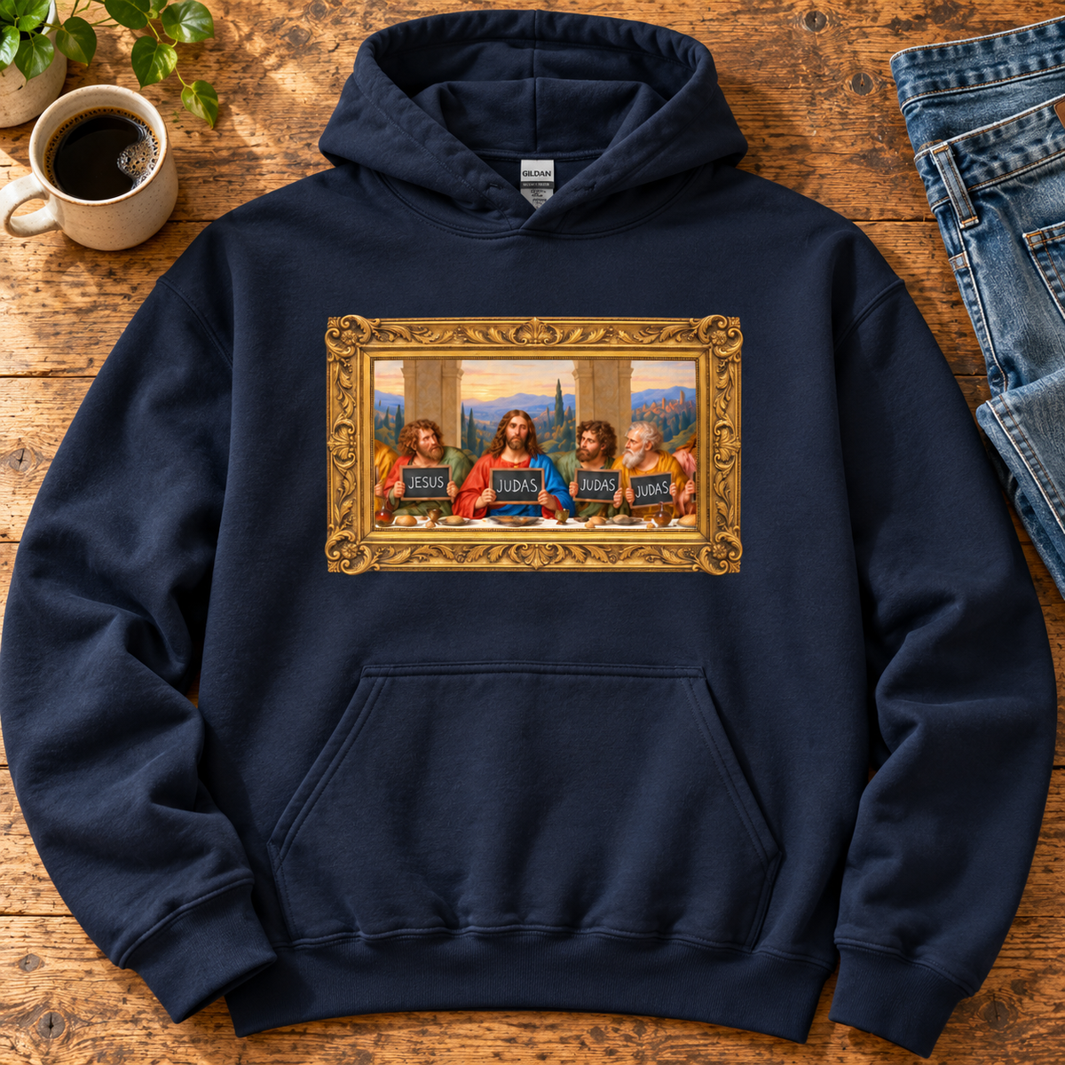Navy hoodie featuring The Original Round Table Last Supper parody in a gold frame, with JESUS and JUDAS chalkboards.